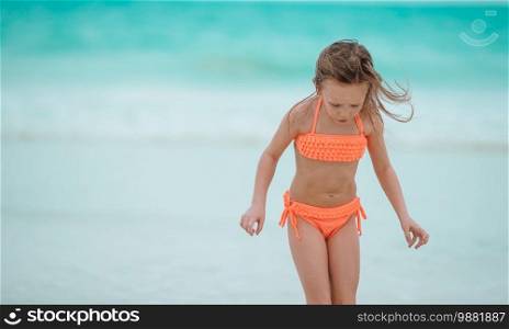 Little cute girl on beach summer vacation. Little girl at beach during summer vacation