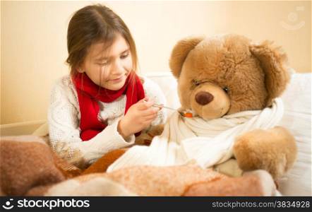Little cute girl playing in hospital with teddy bear