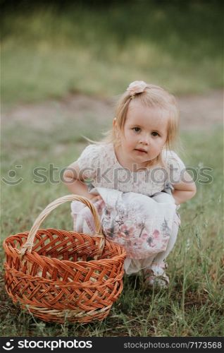 little cute girl with a basket enjoys a sunny day in the park.. little cute girl with a basket enjoys a sunny day in the park