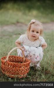 little cute girl with a basket enjoys a sunny day in the park.. little cute girl with a basket enjoys a sunny day in the park