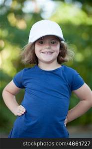 Little cute girl with a cap in the park happy