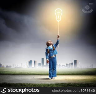 Little cute girl with bulb balloon. Image of little cute girl holding bulb balloon