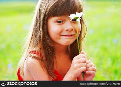 Little cute girl with flower outdoors