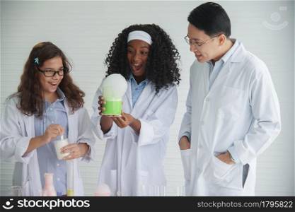 Little diversity African and Caucasian children learning chemistry in school laboratory. Asian Teacher clever little girls doing a chemical science experiment in laboratory on white background