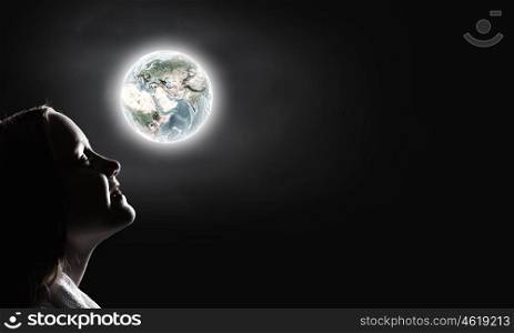 Little dreamer. Cute girl of school age against night background. Elements of this image are furnished by NASA