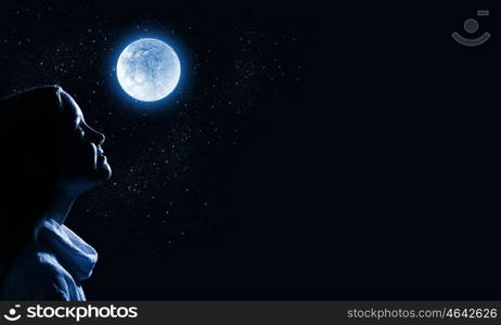 Little dreamer. Cute girl of school age against night background