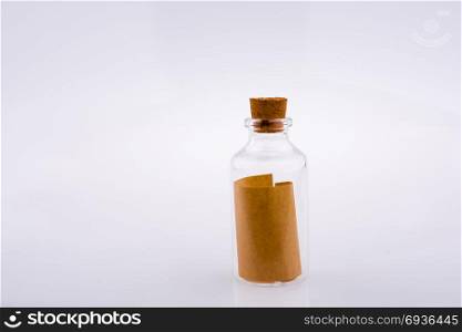 Little empty glass bottle in hand on a white background