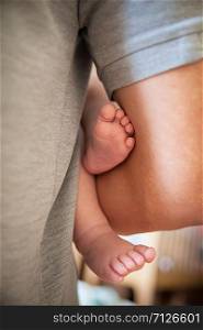 little feet. newborn baby in the arms of his father. little feet. newborn baby