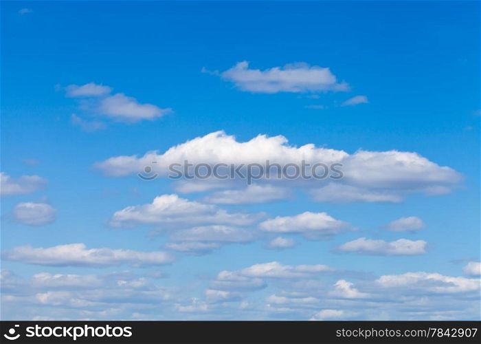 little fluffy white clouds in blue sky in May