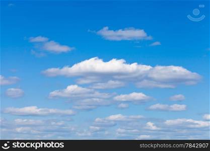 little fluffy white clouds in blue sky in May