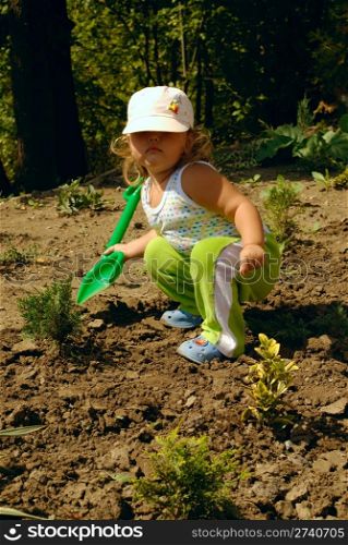little gardener with children shovel. nature