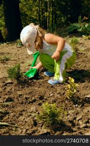 little gardener with children shovel. nature