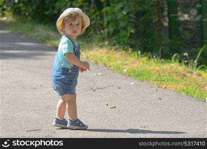 Little girl alone on street in summer