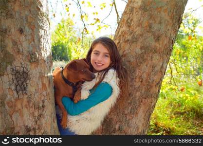 little girl and dog in the forest trees