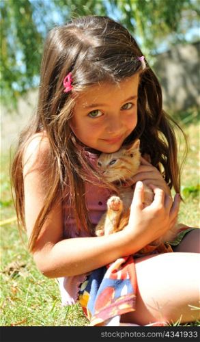 little girl and kitten in a garden
