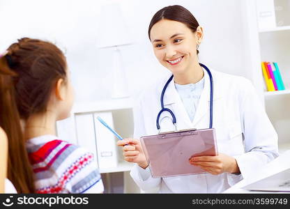 Little girl and young doctor in hospital having examination