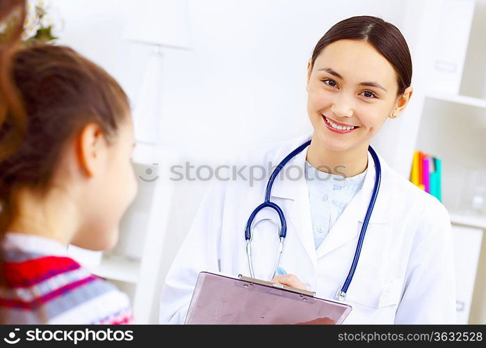 Little girl and young doctor in hospital having examination