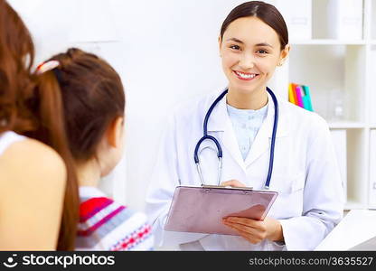 Little girl and young doctor in hospital having examination