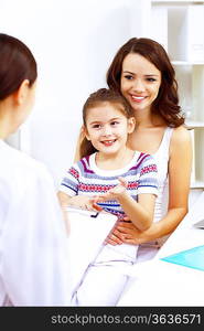 Little girl and young doctor in hospital having examination