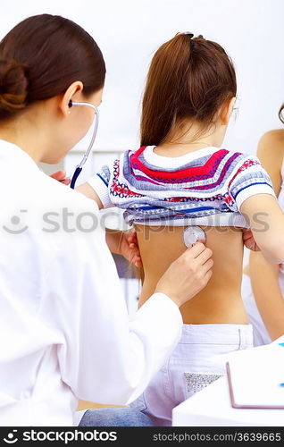 Little girl and young doctor in hospital having examination