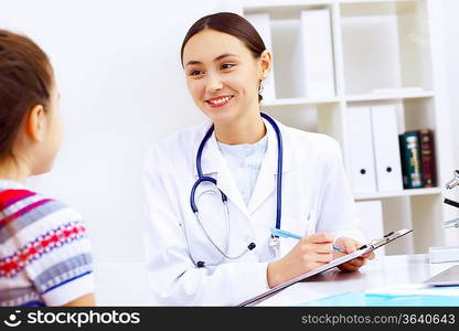 Little girl and young doctor in hospital having examination