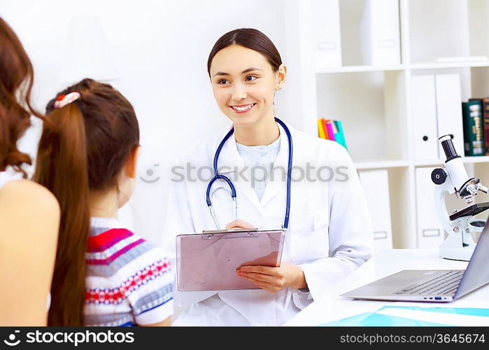 Little girl and young doctor in hospital having examination