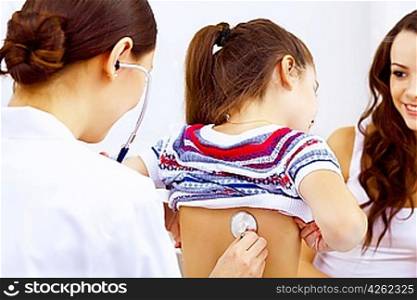 Little girl and young doctor in hospital having examination