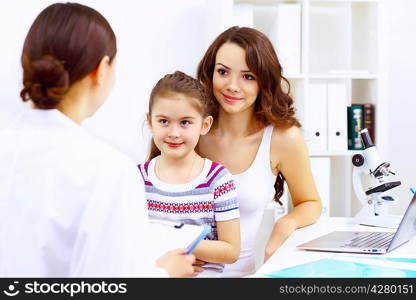 Little girl and young doctor in hospital having examination