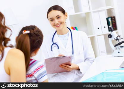 Little girl and young doctor in hospital having examination