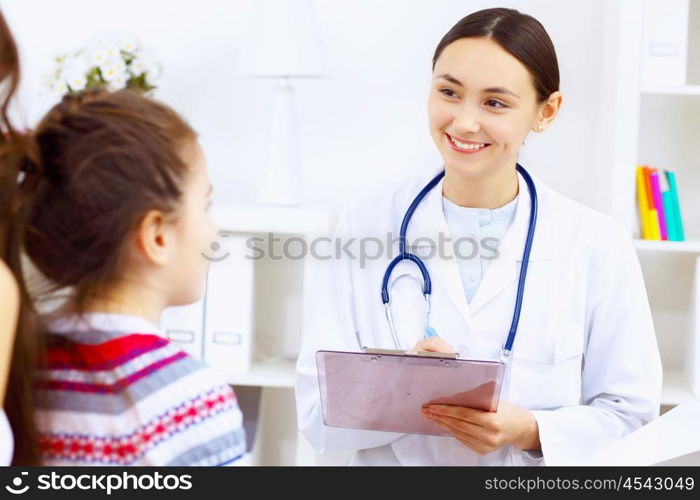 Little girl and young doctor in hospital having examination