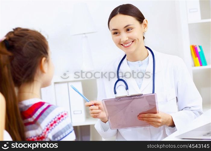 Little girl and young doctor in hospital having examination