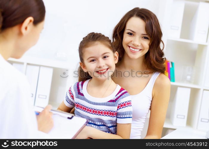 Little girl and young doctor in hospital having examination