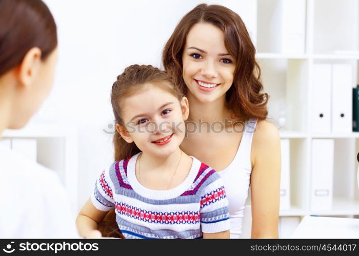 Little girl and young doctor in hospital having examination