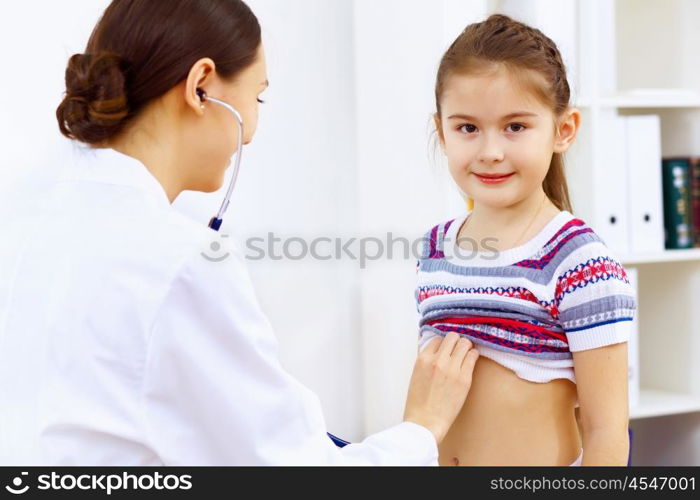 Little girl and young doctor in hospital having examination