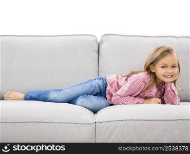 Little girl at home lying on a couch