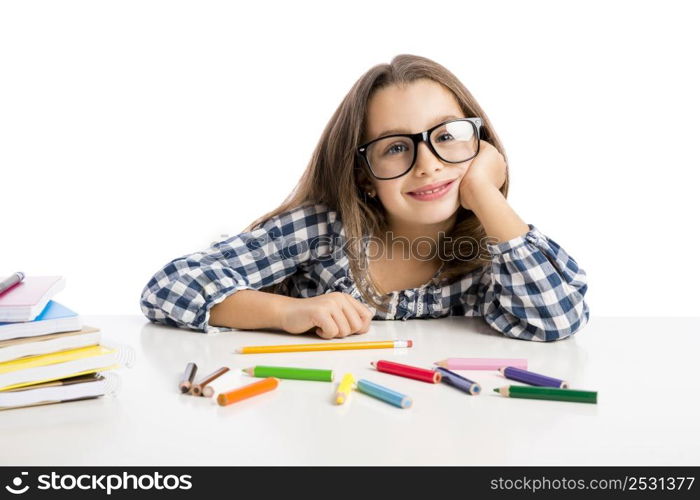 Little girl at school making drawings and painting