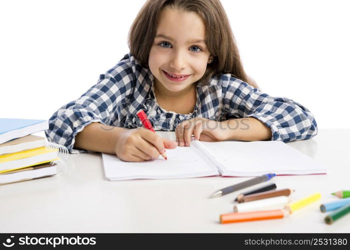 Little girl at school making drawings and painting