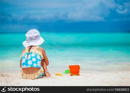 Little girl at tropical beach making sand castle. Little girl at tropical white beach making sand castle