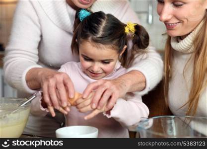 Little girl baking with her family