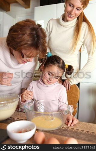 Little girl baking with her mother and grandma