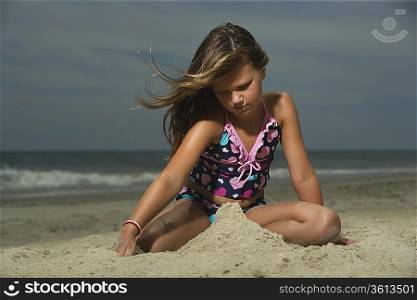 Little Girl Building a Sand Castle