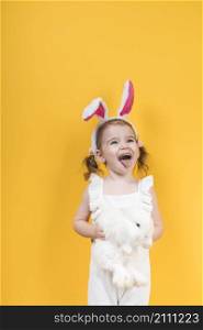 little girl bunny ears with rabbit showing tongue