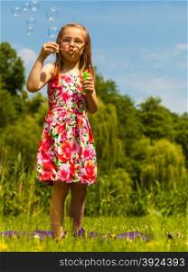 Little girl child blowing bubbles outdoor.. Little girl child blowing bubbles outdoor. Kid having fun in park. Happy and carefree childhood.