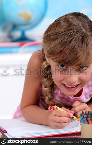 Little girl colouring with crayons