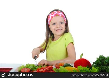 little girl cut fresh tomatoes. Isolated on white background