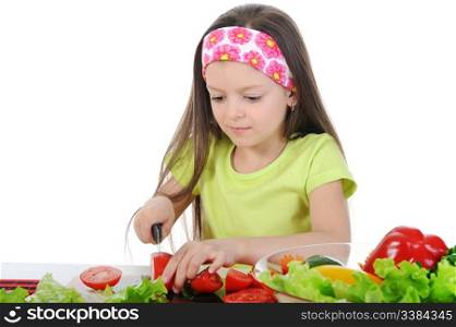 little girl cut fresh tomatoes. Isolated on white background