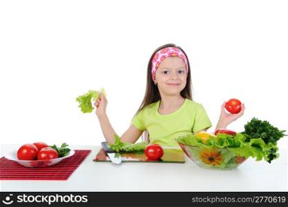 Little girl cut tomatoes at the table. Isolated on white background