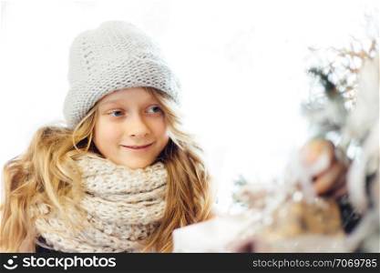 Little girl decorating the Christmas tree. Shallow depth of field.