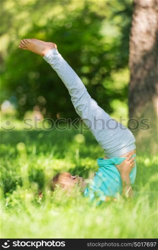 Little girl doing gymnastic exercises at park