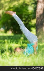 Little girl doing gymnastic exercises at park